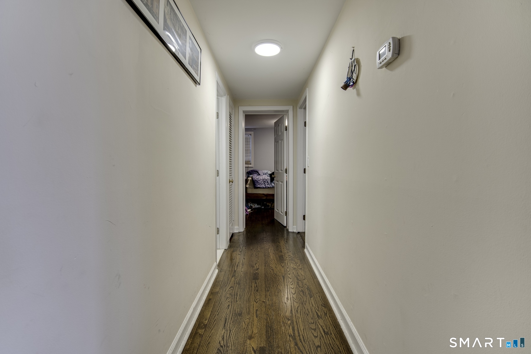 183 Sugar Street Newtown, CT 06470 - Photo 8 of 40 a view of a hallway with wooden floor and staircase
