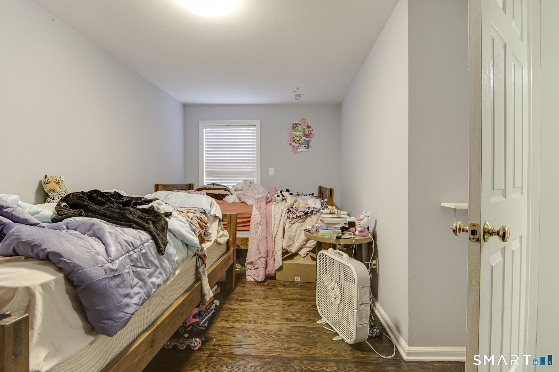 183 Sugar Street Newtown, CT 06470 - Photo 10 of 40 a bed room with a bed and a chandelier