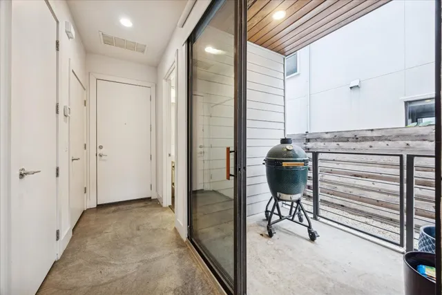 a view of a hallway with bathroom