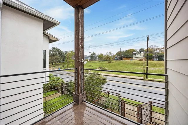 a view of a balcony with a yard