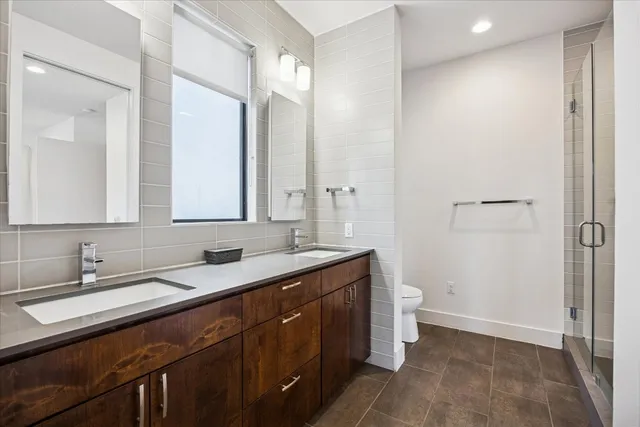 a bathroom with a double vanity sink and mirror