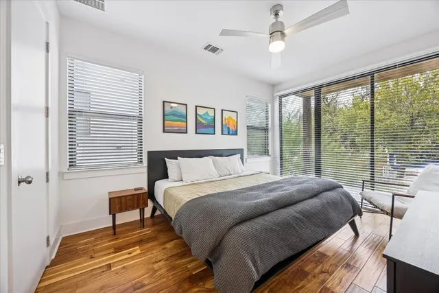 a bedroom with a bed and a large window