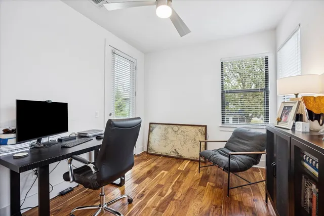 a work room with furniture and a flat screen tv