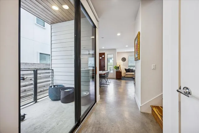 a view of hallway with livingroom and furniture