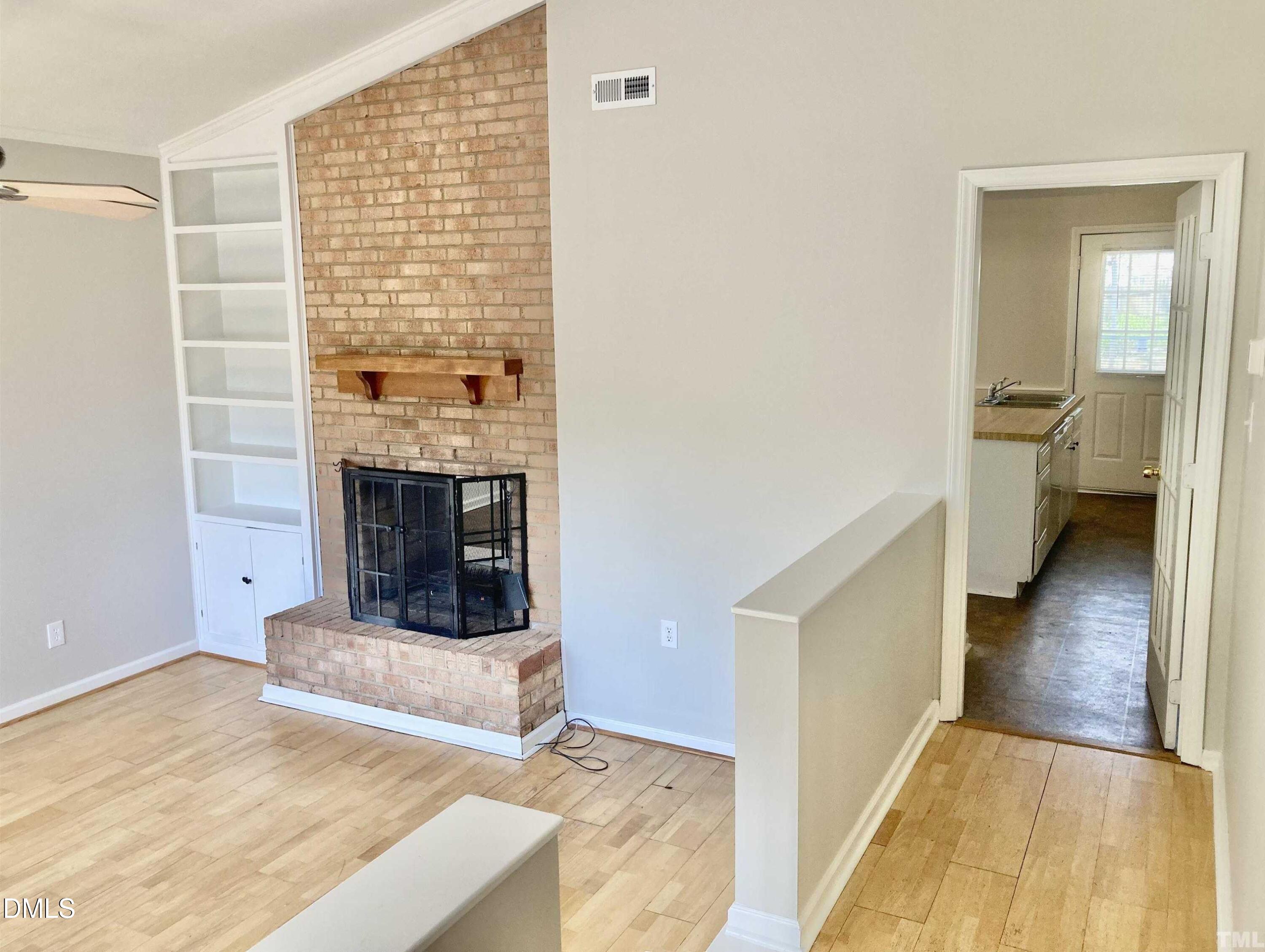 104 Castill Place Garner, NC 27529 - Photo 2 of 11 a view of a livingroom with wooden floor and a fireplace