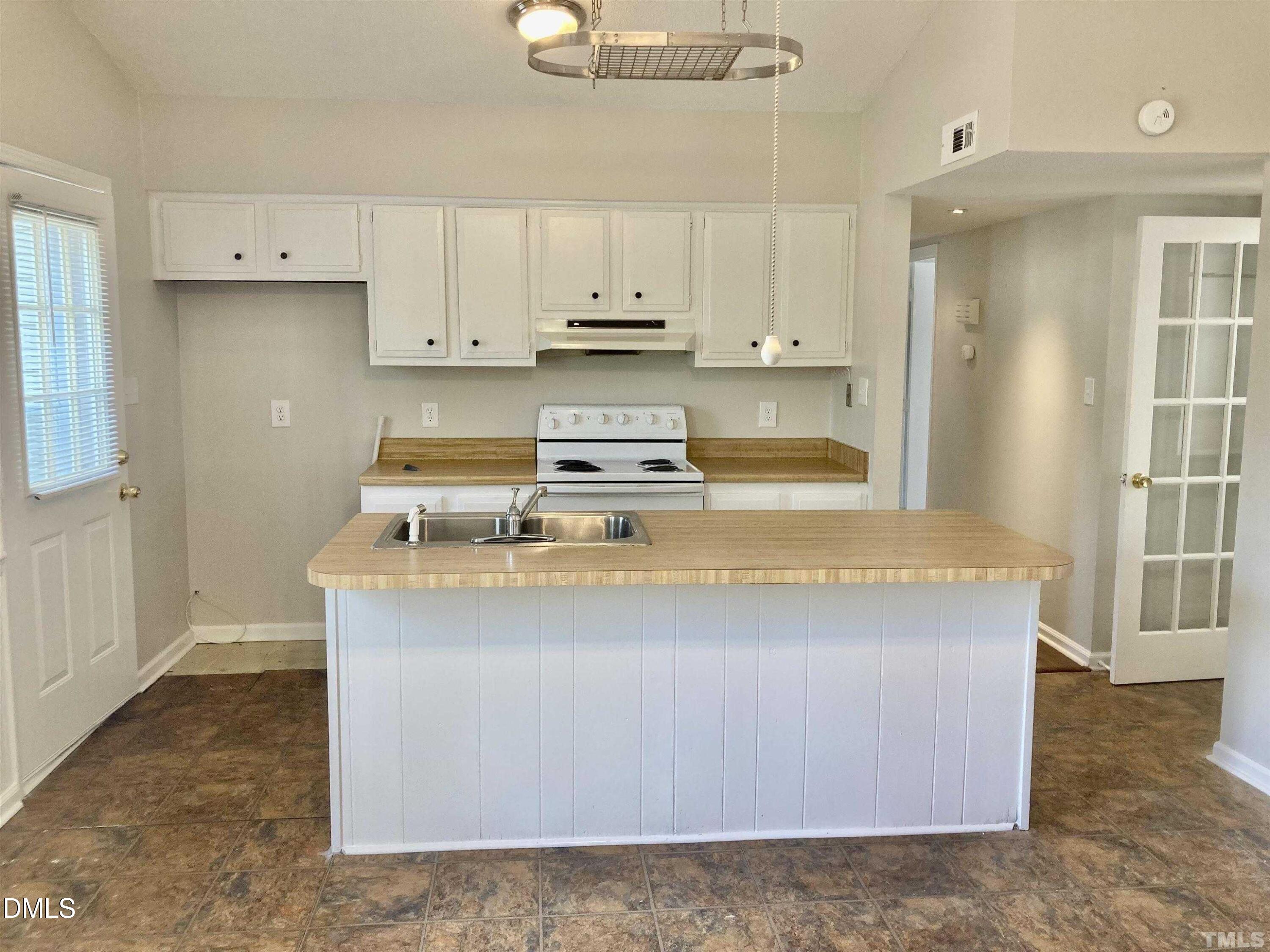 104 Castill Place Garner, NC 27529 - Photo 3 of 11 a kitchen with kitchen island sink stove and cabinets