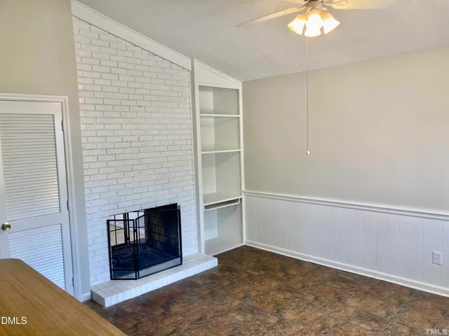a view of an empty room with a fireplace