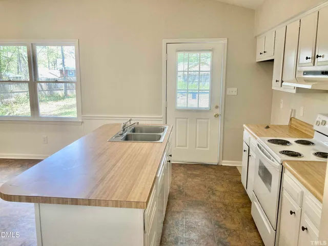 a kitchen that has a sink and a stove