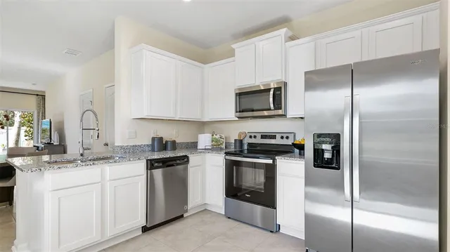 a kitchen with a sink stainless steel appliances and cabinets