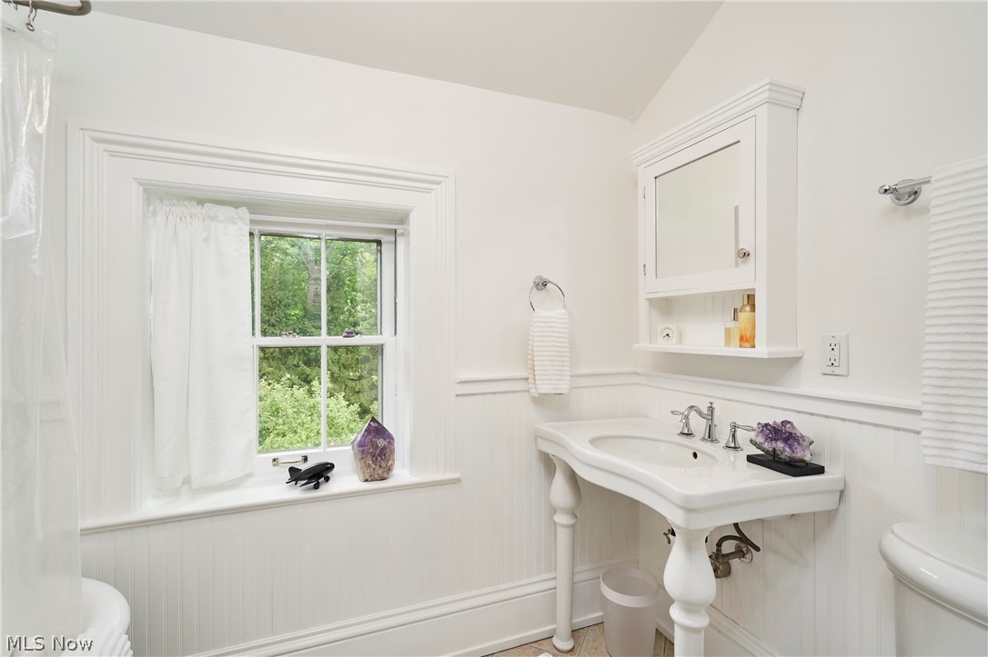 5046 Alger Road Richfield, OH 44286 - Photo 36 of 49 White bathroom featuring beadboard wainscoting, a pedestal sink with chrome fixtures, and a recessed medicine cabinet