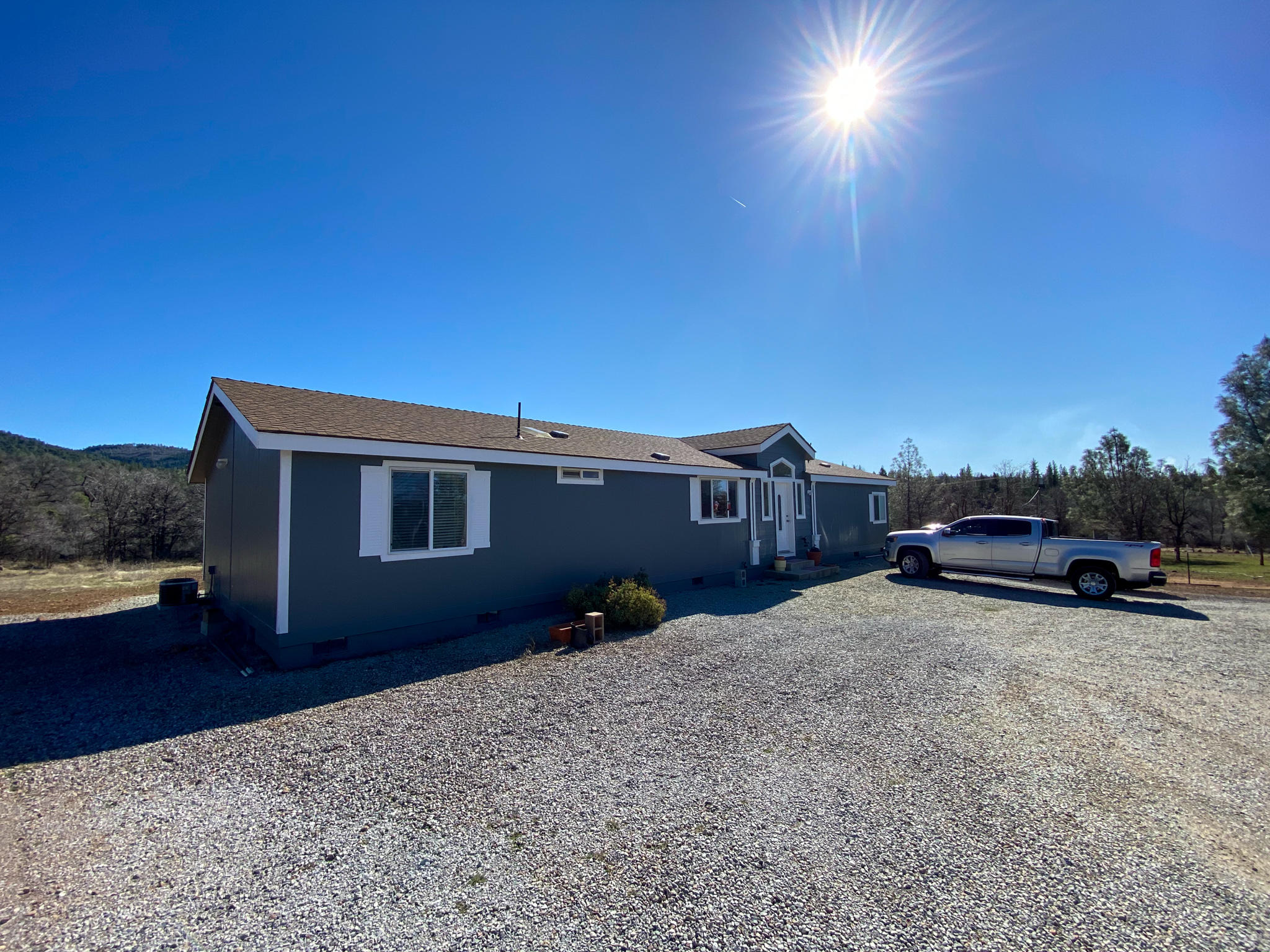 31668 Grindley Ranch Road Whitmore, CA 96096 - Photo 1 of 26 a front view of a house with a yard