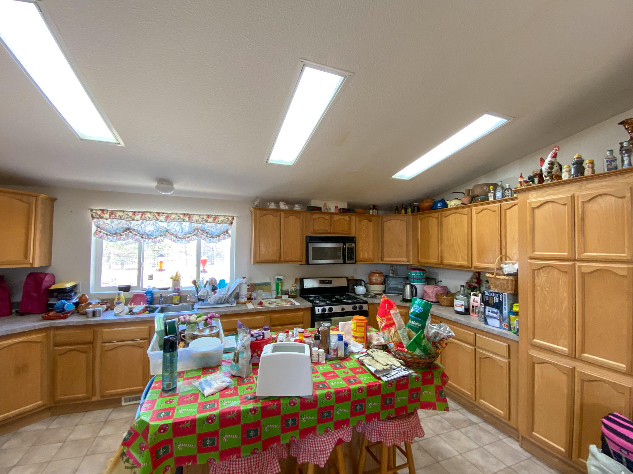 31668 Grindley Ranch Road Whitmore, CA 96096 - Photo 18 of 26 a kitchen filled with a white appliances a sink dishwasher a microwave oven and a dining table with wooden cabinet
