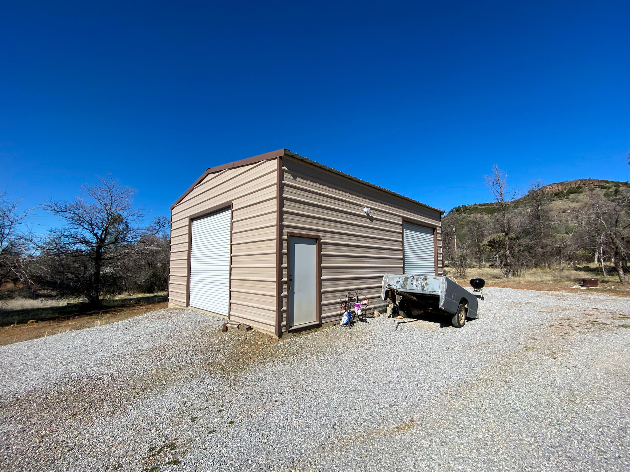 31668 Grindley Ranch Road Whitmore, CA 96096 - Photo 2 of 26 a view of a house with a backyard