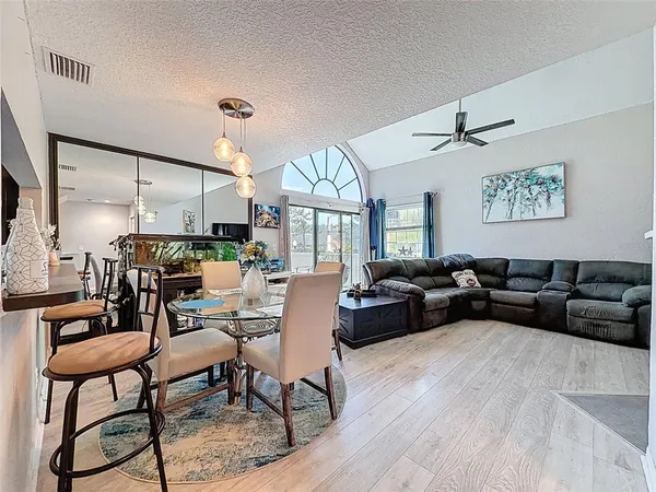 a view of a dining room with furniture window and wooden floor