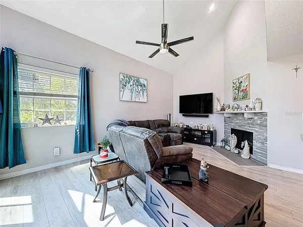 an outdoor sitting area with furniture and wooden floor