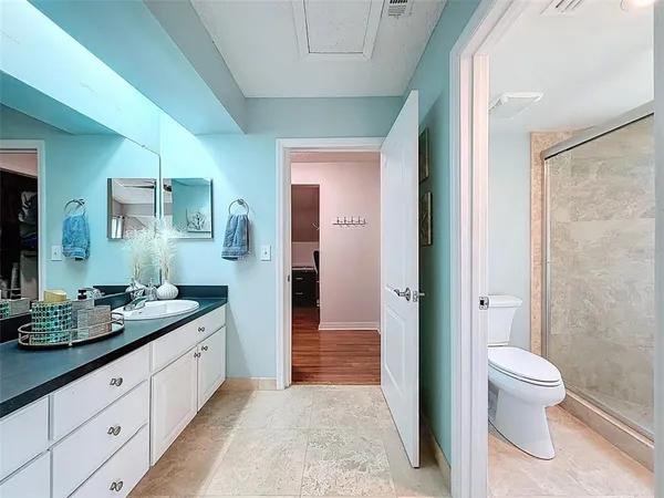 a view of a bedroom with workspace and furniture