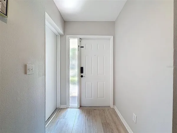 a vase of flowers sitting on a floor