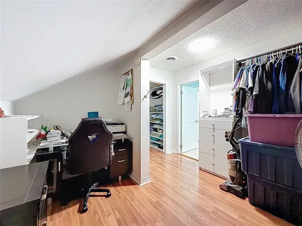 an aerial view of residential houses with outdoor space and trees