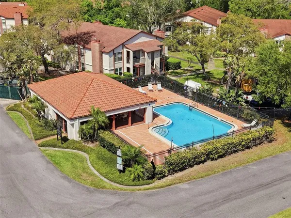 a view of a city and lush green forest