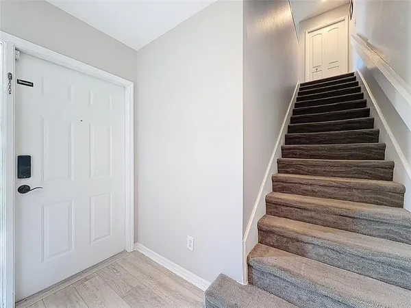 a view of a living room with furniture and wooden floor
