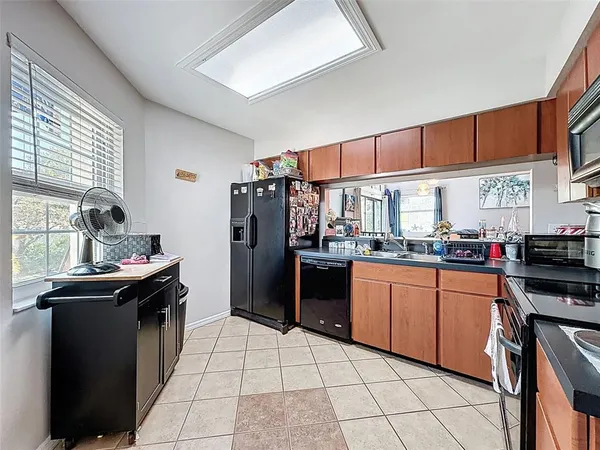a kitchen with stainless steel appliances granite countertop a refrigerator and a stove top oven
