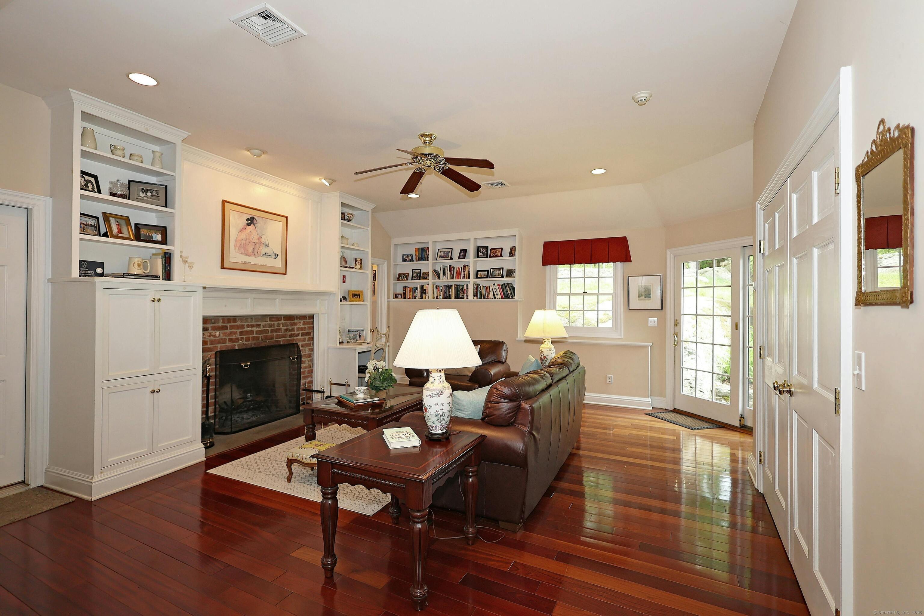 252 Florida Hill Road Ridgefield, CT 06877 - Photo 12 of 40 a living room with furniture a fireplace and a large window