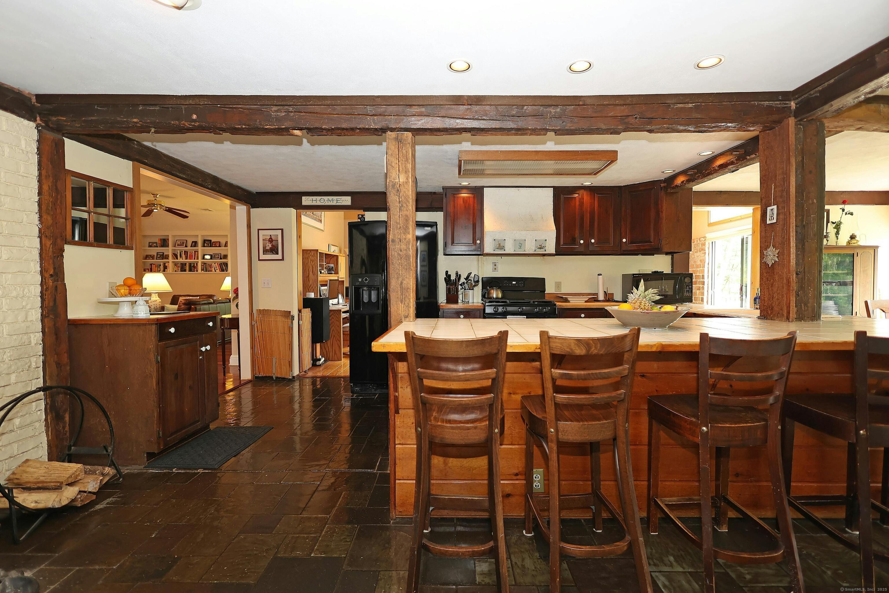 252 Florida Hill Road Ridgefield, CT 06877 - Photo 19 of 40 a kitchen with a dining table chairs and large windows