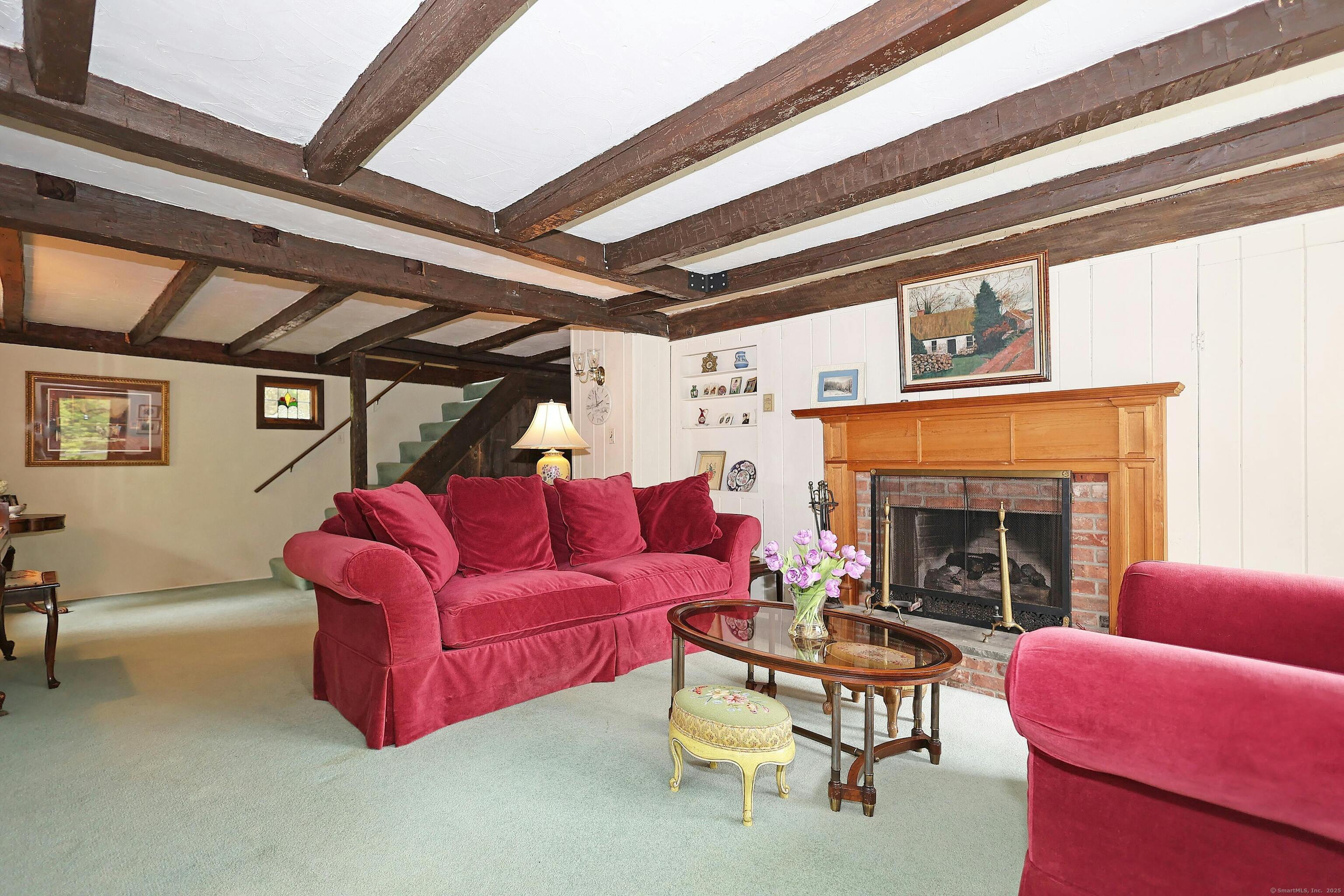 252 Florida Hill Road Ridgefield, CT 06877 - Photo 22 of 40 a living room with furniture a fireplace and a large window