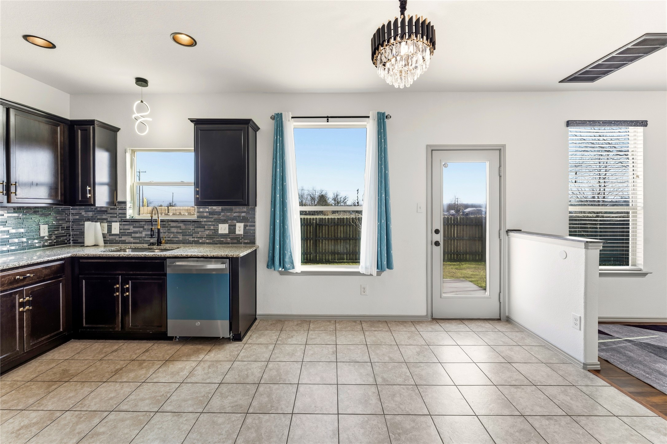 100 Serpentine Lane Jarrell, TX 76537 - Photo 15 of 40 a large kitchen with a stove a sink dishwasher a refrigerator and a microwave oven