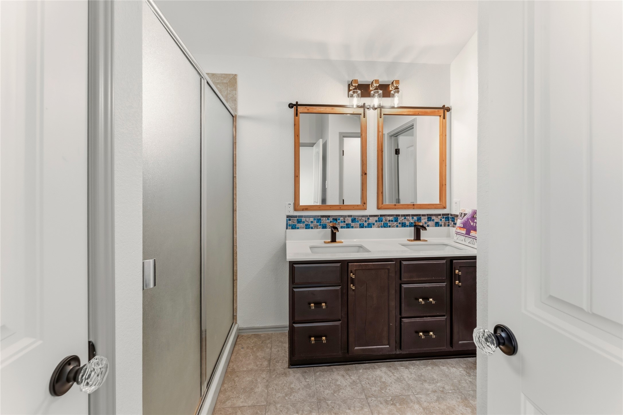 100 Serpentine Lane Jarrell, TX 76537 - Photo 27 of 40 a bathroom with a granite countertop sink and a mirror