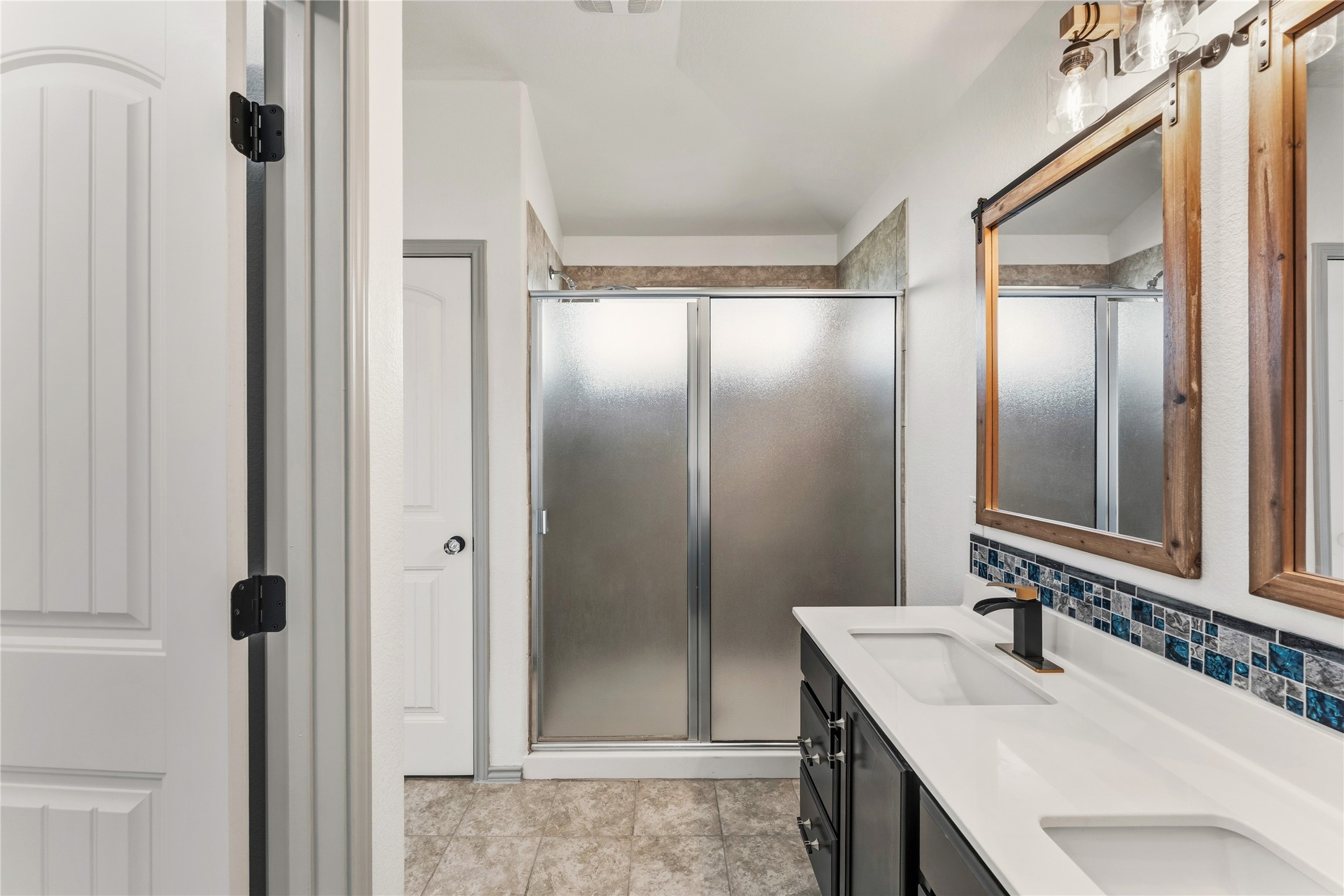 100 Serpentine Lane Jarrell, TX 76537 - Photo 28 of 40 a bathroom with a double vanity sink mirror and shower