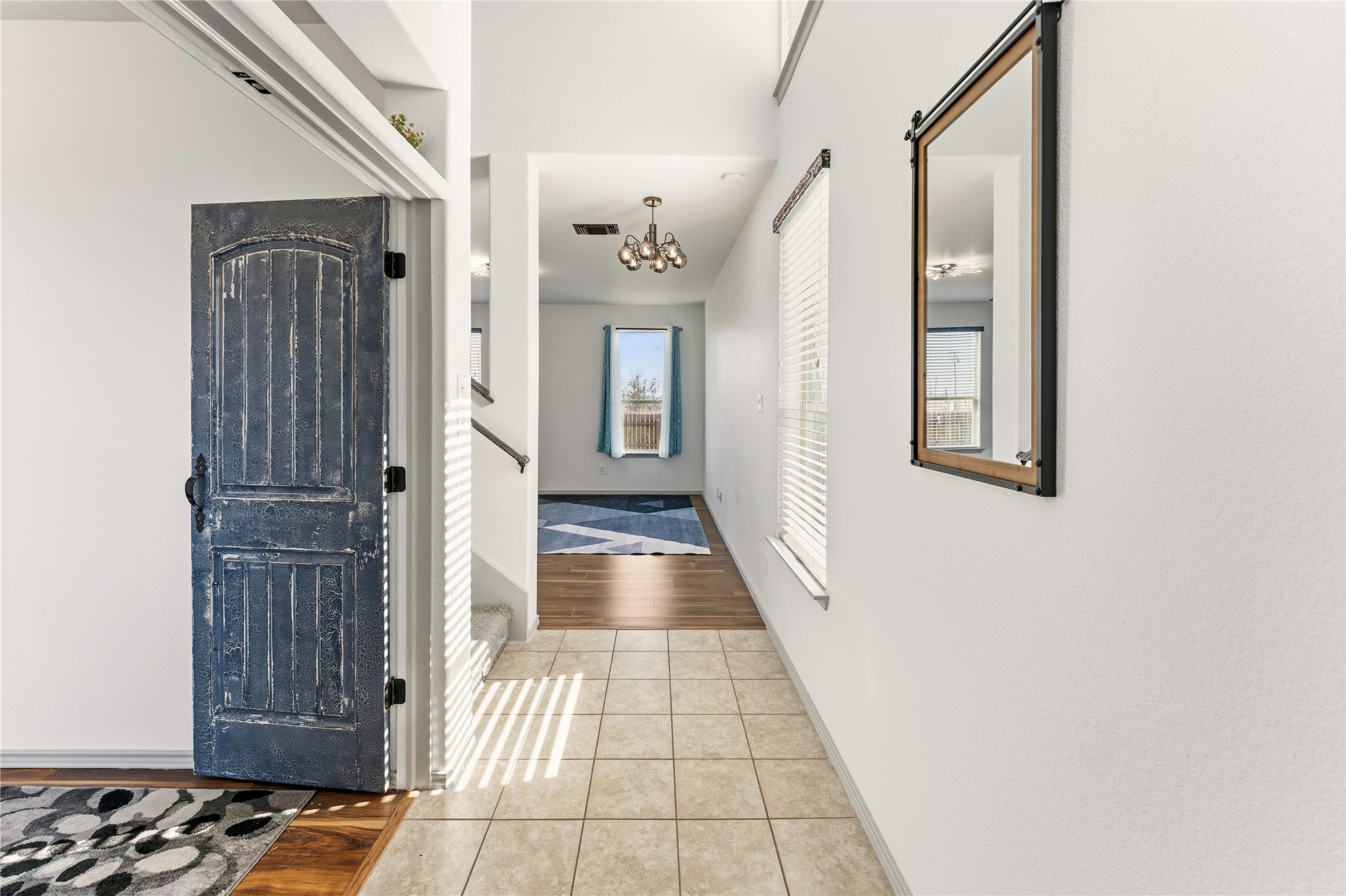 100 Serpentine Lane Jarrell, TX 76537 - Photo 5 of 40 a view of a hallway with wooden floor and staircase
