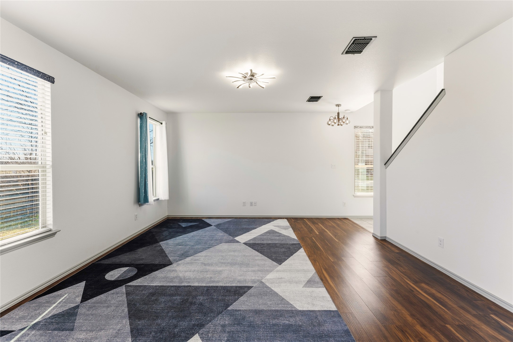 100 Serpentine Lane Jarrell, TX 76537 - Photo 10 of 40 a view of an empty room with wooden floor and a window