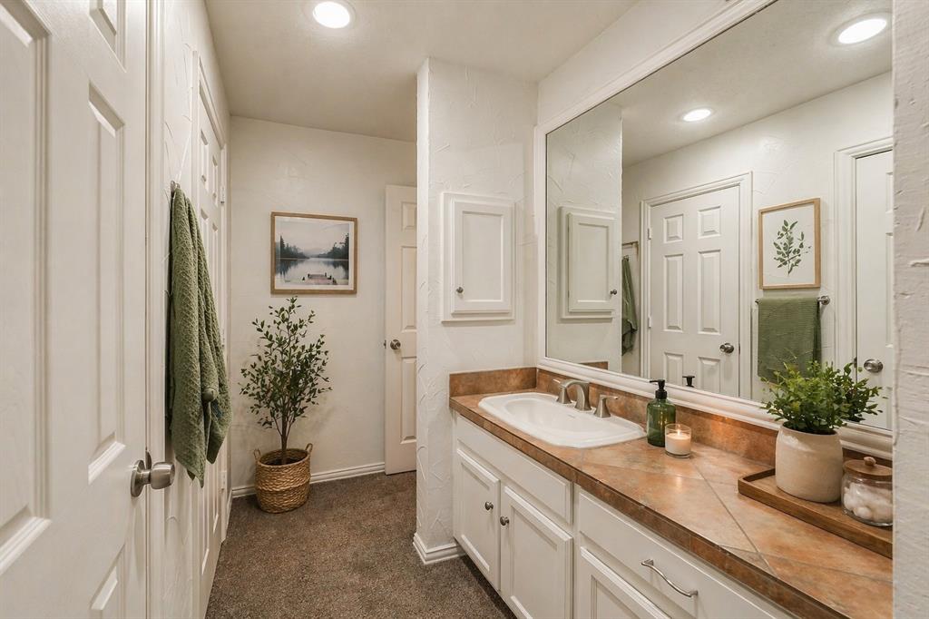 9999 Boat Club Road, Unit 311 Fort Worth, TX 76179 - Photo 11 of 25 a bathroom with a granite countertop sink and a mirror