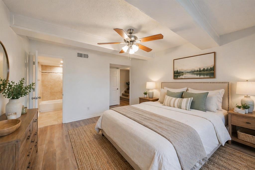 9999 Boat Club Road, Unit 311 Fort Worth, TX 76179 - Photo 12 of 25 a bedroom with a bed and a chandelier