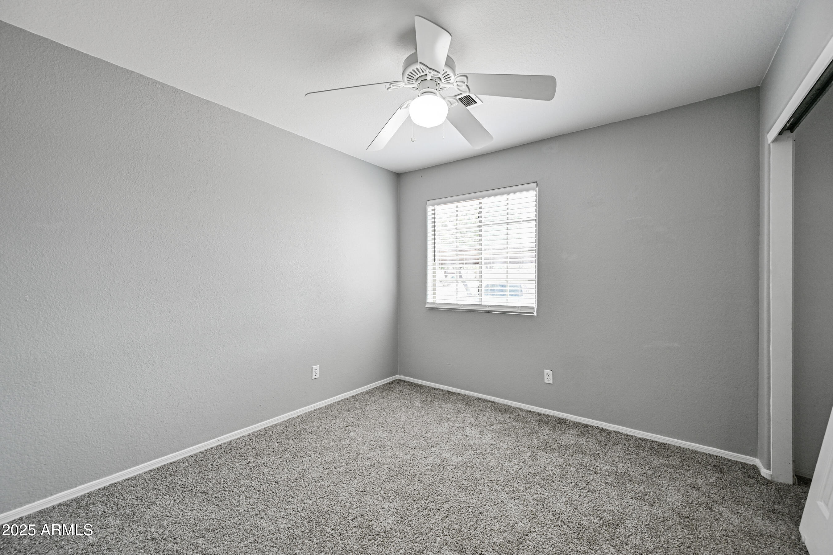 726 South Nebraska Street, Unit 91 Chandler, AZ 85225 - Photo 17 of 20 an empty room with windows and fan
