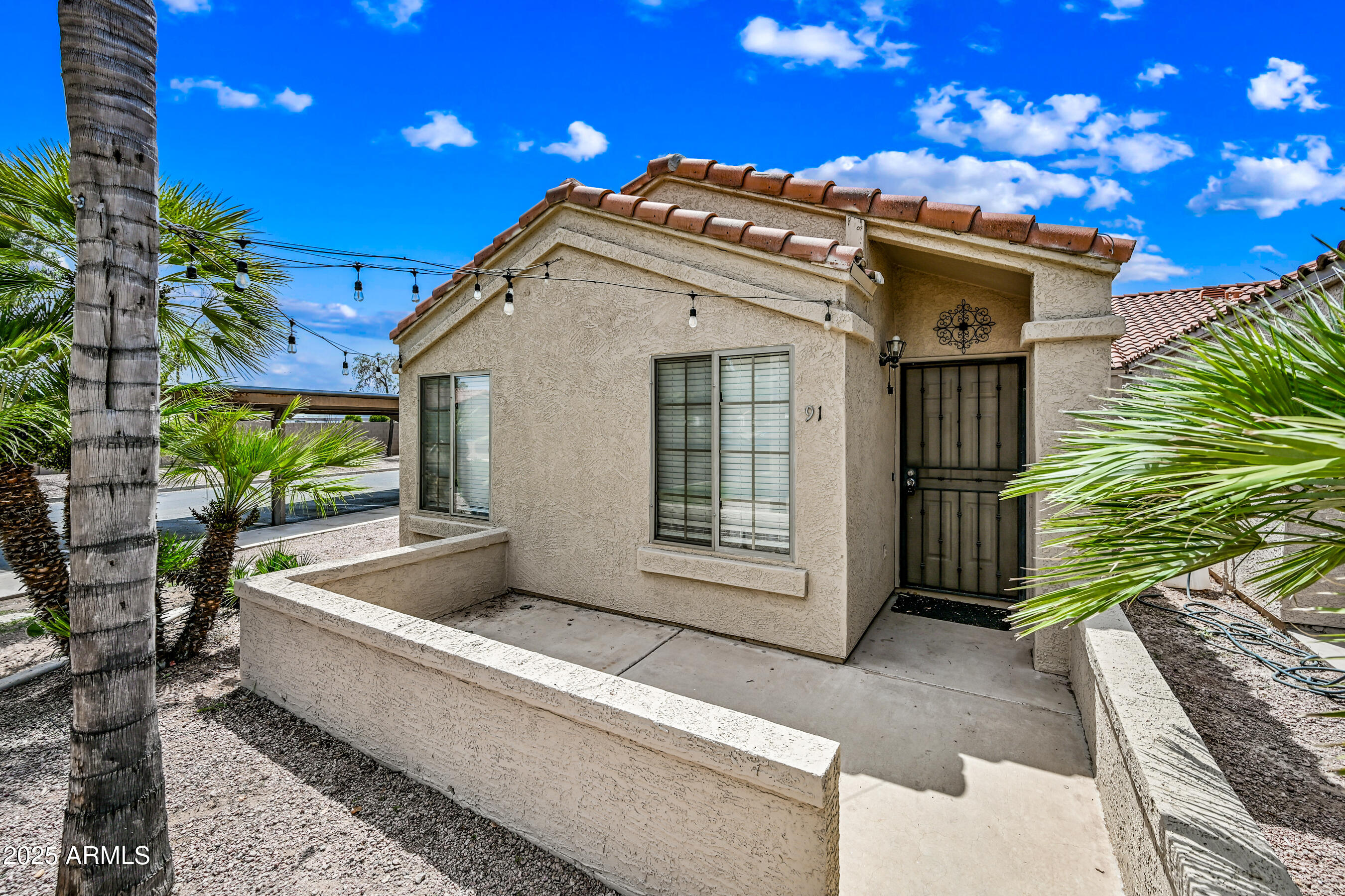 726 South Nebraska Street, Unit 91 Chandler, AZ 85225 - Photo 2 of 20 a front view of a house with a yard