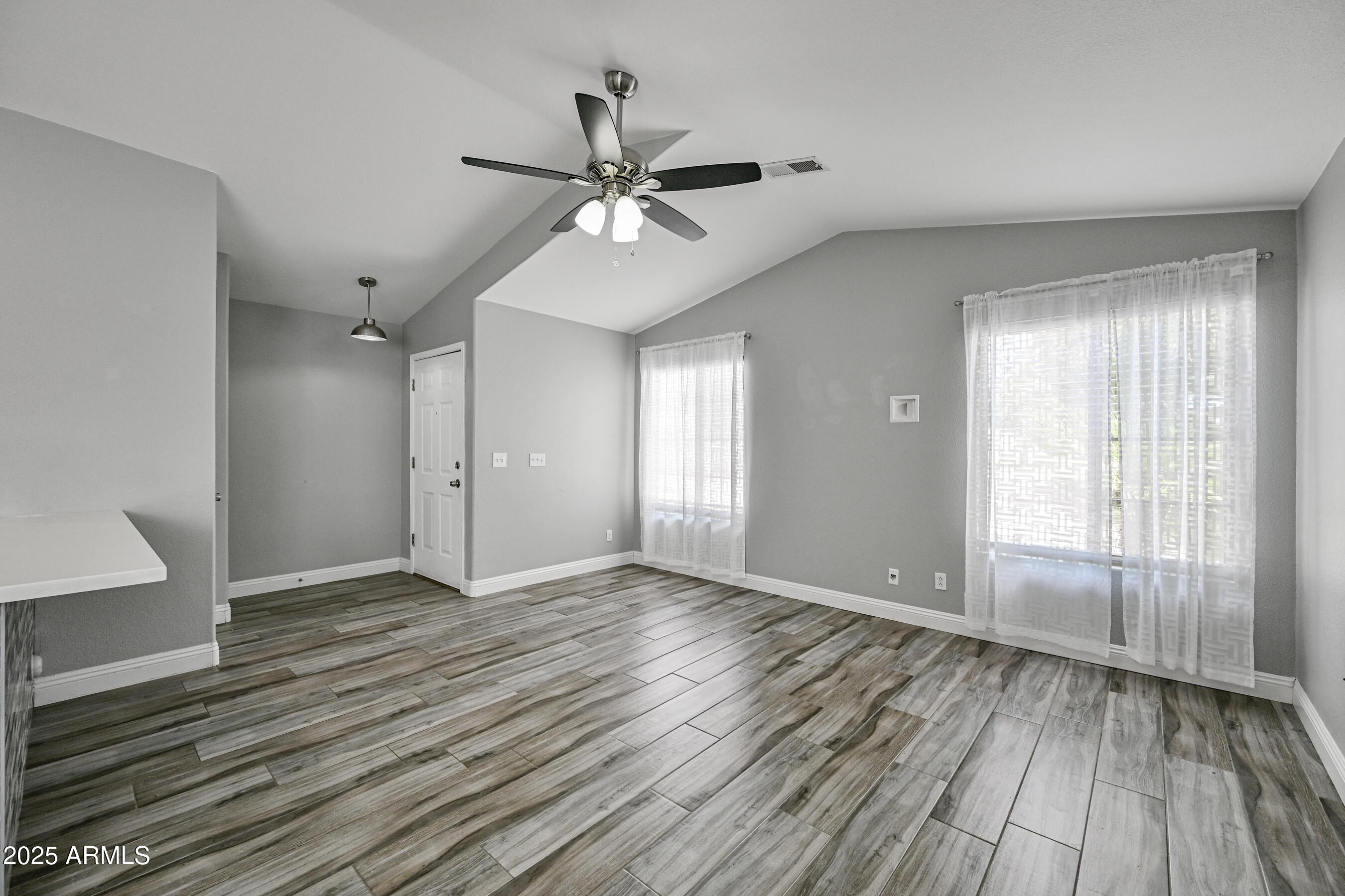 726 South Nebraska Street, Unit 91 Chandler, AZ 85225 - Photo 5 of 20 a view of an empty room with wooden floor and a window