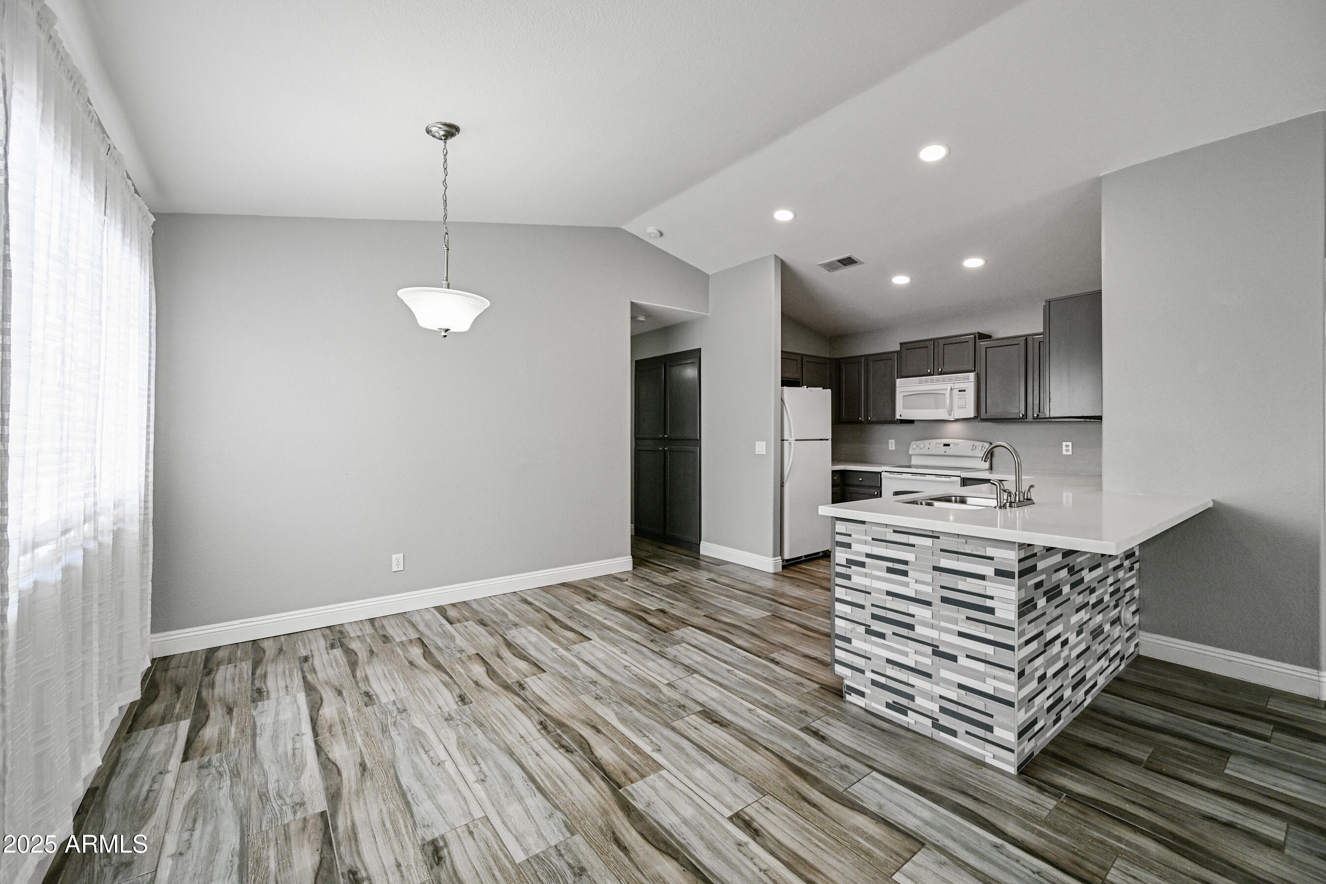 726 South Nebraska Street, Unit 91 Chandler, AZ 85225 - Photo 8 of 20 a kitchen with stainless steel appliances granite countertop a sink stove and refrigerator