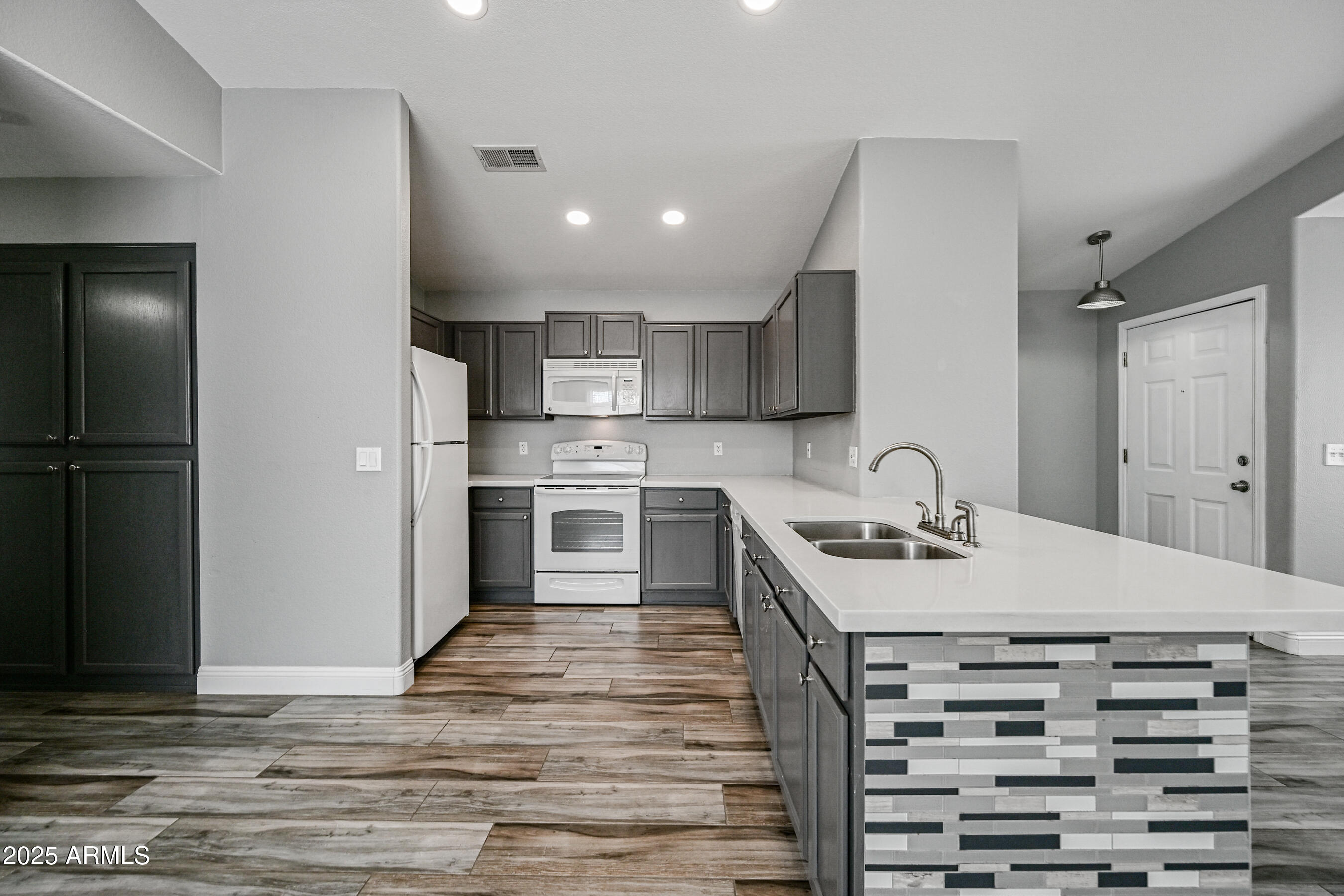 726 South Nebraska Street, Unit 91 Chandler, AZ 85225 - Photo 9 of 20 a kitchen with a refrigerator and a sink