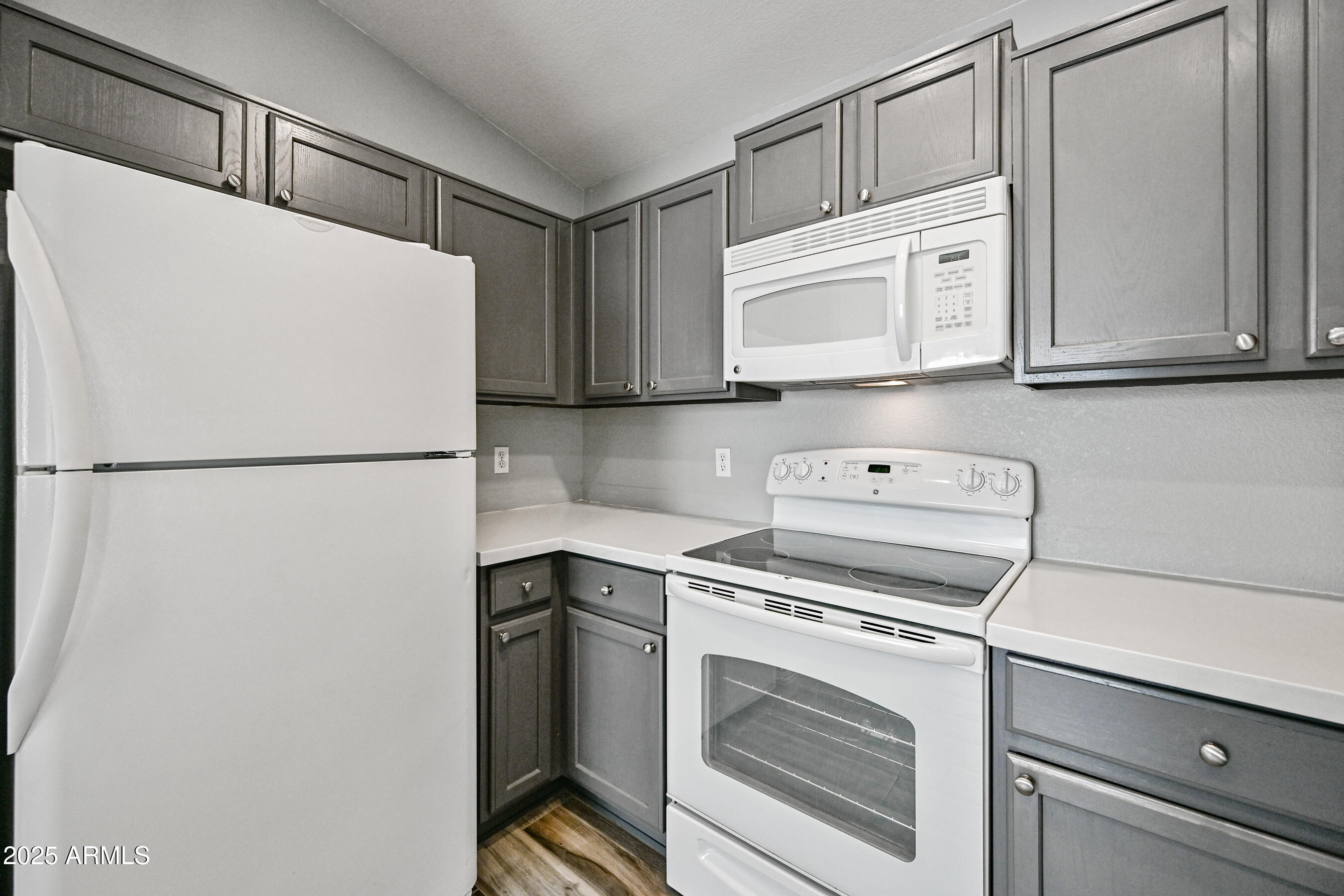 726 South Nebraska Street, Unit 91 Chandler, AZ 85225 - Photo 10 of 20 a kitchen with a refrigerator sink stove and cabinets