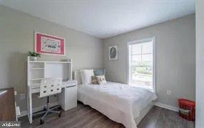a bedroom with a bed and a window