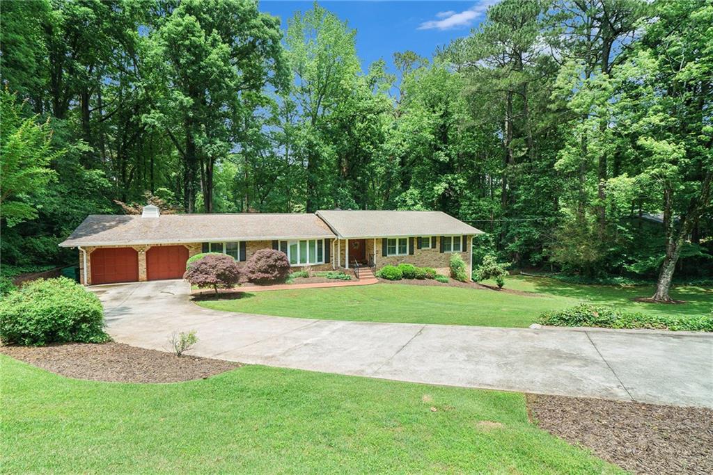 5170 Oxbow Road Stone Mountain, GA 30087 - Photo 1 of 1 a view of a house with a yard and sitting area