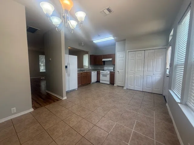 a view of a kitchen with a sink and a refrigerator