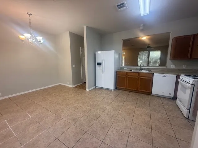 a large kitchen with cabinets and stainless steel appliances