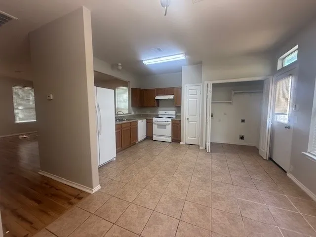 a view of a kitchen with a sink and a refrigerator