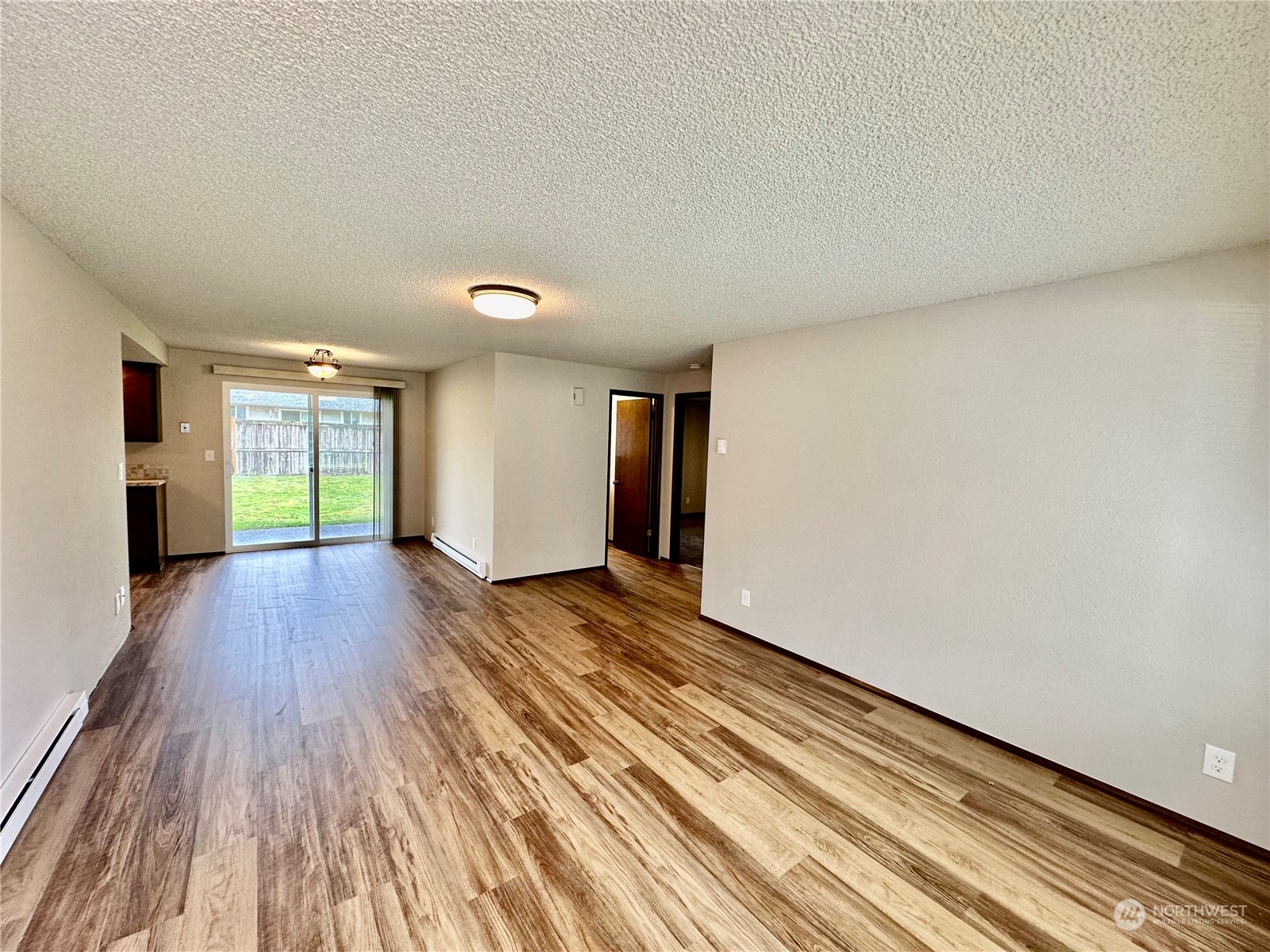 5115-5117 187th Trail Southwest Rochester, WA 98579 - Photo 5 of 34 a view of empty room with wooden floor and fan