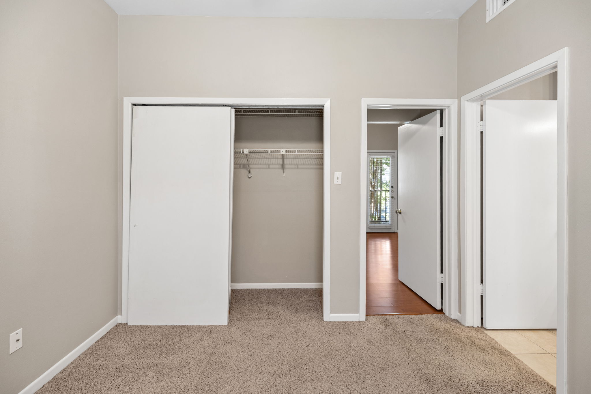 712 Graham Place, Unit 203 Austin, TX 78705 - Photo 22 of 30 wooden floor and closet in a room