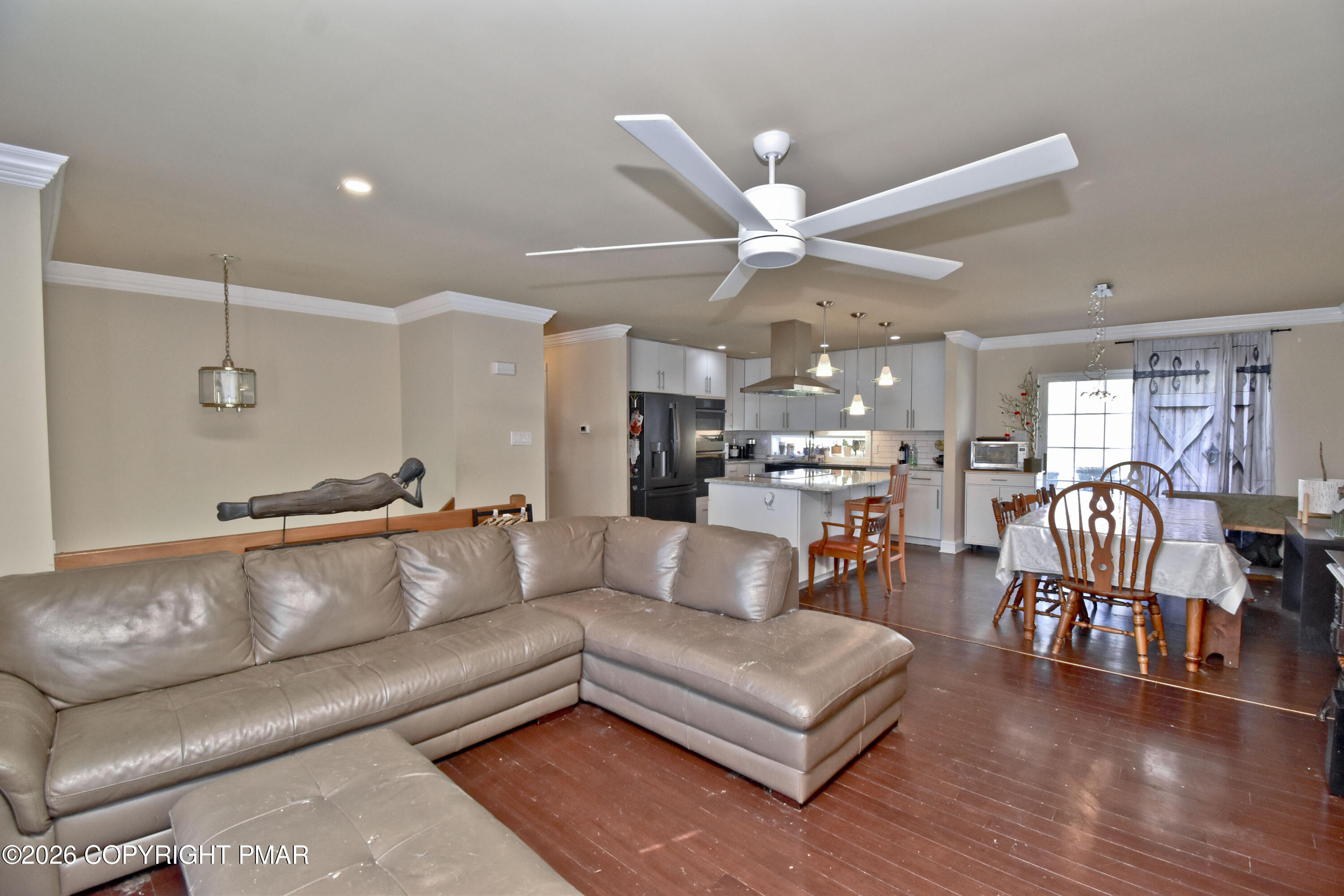 2106 Smith Road Stroudsburg, PA 18360 - Photo 4 of 34 a view of living room kitchen with a dining table and a ceiling fan