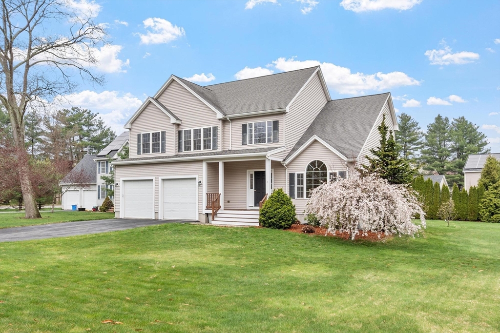 4 Henley Road Acton, MA 01720 - Photo 1 of 32 a front view of a house with a garden and plants